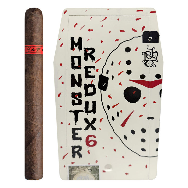 Tatuaje The Jason Redux 6 cigar standing beside its closed white Monster Series coffin box with hockey-mask artwork